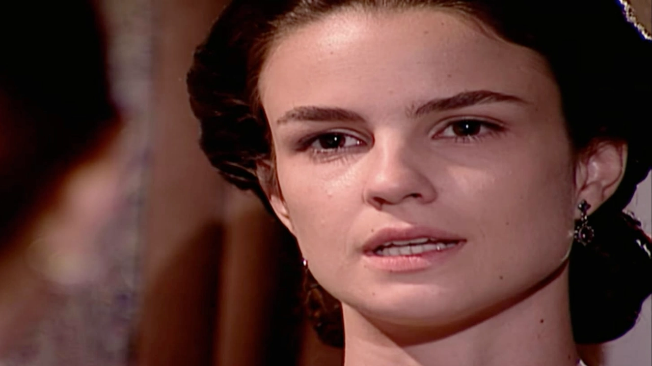 Resumo Terra Nostra 15/04: Rosana entra em DESESPERO após CRIME CRUEL de Gumercindo 2 A personagem Rosana com expressão intensa e séria na novela Terra Nostra